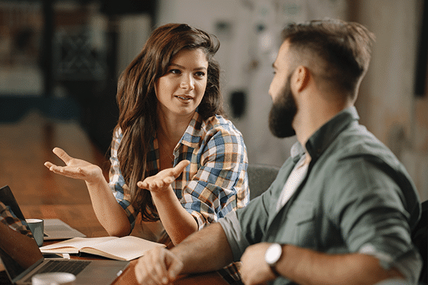 Two people having a discussion at work.